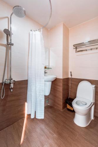 a bathroom with a toilet and a sink at AQUA Seaview Hotel in Nha Trang
