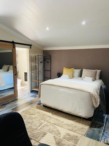 a bedroom with a large white bed in a room at Redem House in Modimolle