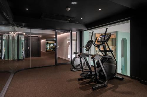a gym with two tread machines in a room at Myhotel Cmyk@Ratchada in Bangkok
