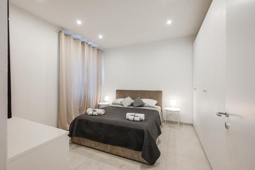 a bedroom with a bed with two towels on it at La Scaletta 10 min from train station for Cinque Terre! in La Spezia