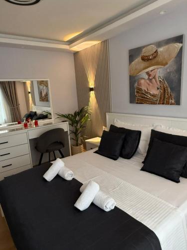 a bedroom with a large bed with two towels on it at Abla's sweet home in Tirana