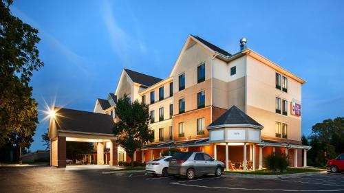a hotel with a car parked in a parking lot at Best Western Plus Kalamazoo Suites in Kalamazoo
