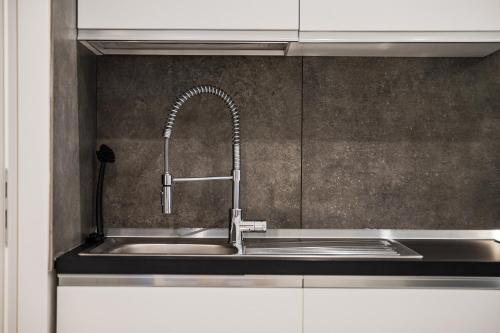 a stainless steel sink with a faucet in a kitchen at La Scaletta 10 min from train station for Cinque Terre! in La Spezia