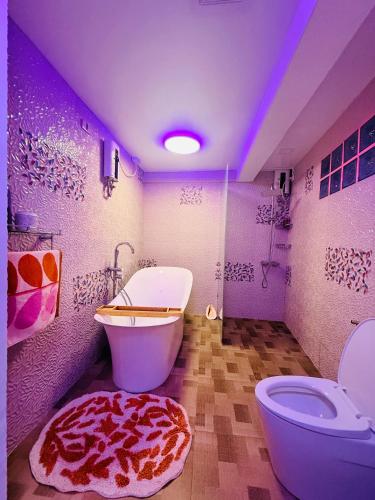 a bathroom with a pizza rug next to a toilet at Lala Panzi Bed and Breakfast in Puerto Princesa City