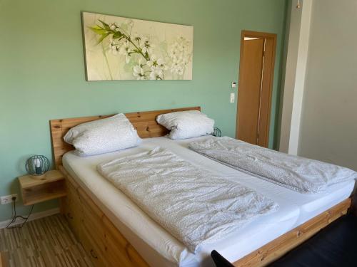 a bed in a room with a picture on the wall at Ferienhaus Dresden in Dresden