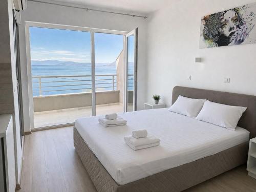 a bedroom with a large bed and a large window at Apartments Marko in Ohrid