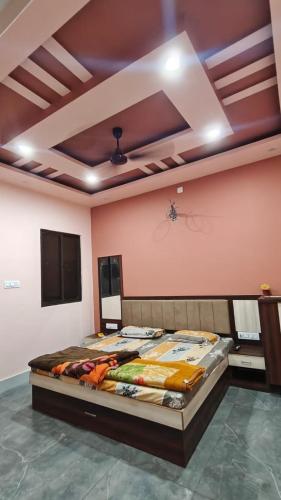 a large bed in a room with a ceiling at MMB Hotel in Bikaner