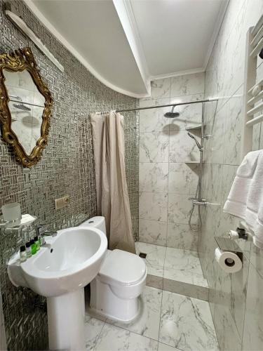 a bathroom with a toilet and a sink and a mirror at 34 Silver Rooms in Tbilisi City