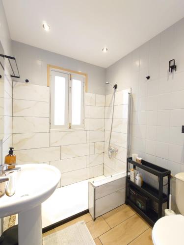 a bathroom with a shower and a sink and a tub at La Casita de Puerto in Puerto del Rosario