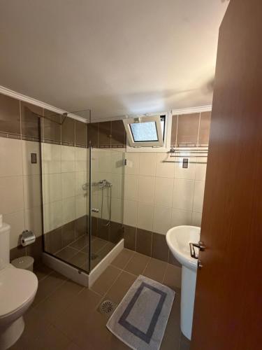 a bathroom with a shower and a toilet and a sink at Villa Alexandra in Agia Marina Aegina