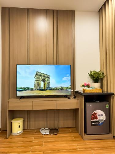 a flat screen tv sitting on a stand in a room at AnChi Homestay in Hòa Bình