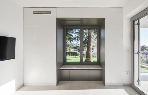 a window in a white room with a window seat at Forgotten Garden Villa in Portorož