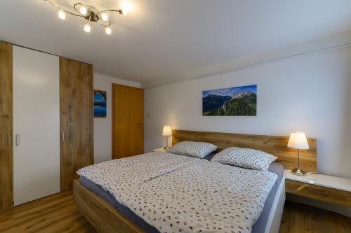 a bedroom with a large bed with two pillows at Ferienwohnung Werner Pucher OG in Altaussee