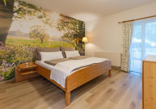 a bedroom with a bed with a painting on the wall at Landhaus Bender Ferienwohnung mit Terrasse und Garten in Straden