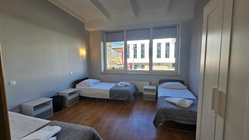 a room with two beds and a window at Valmiera Park Hostel in Valmiera