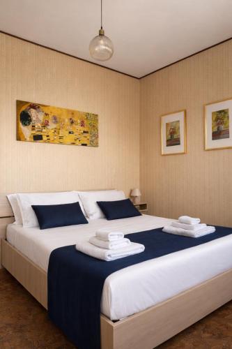 a bedroom with a large bed with towels on it at ELIOS Grand Apartment in Tropea