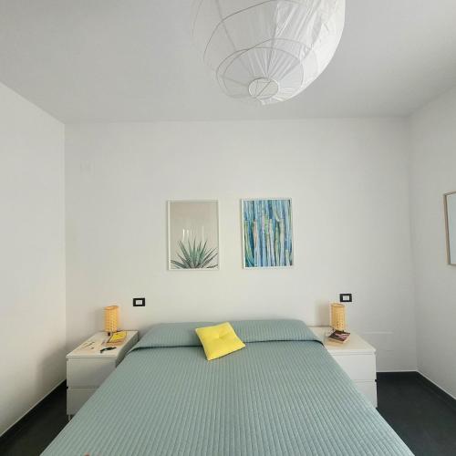 a bedroom with a bed with a yellow pillow on it at Al Molino delle Ghiare in Levanto