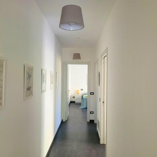 a hallway with white walls and a door to a room at Al Molino delle Ghiare in Levanto