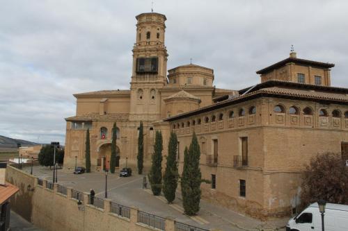 a large building with a clock tower on top of it at Hospedería de Alesves in Villafranca