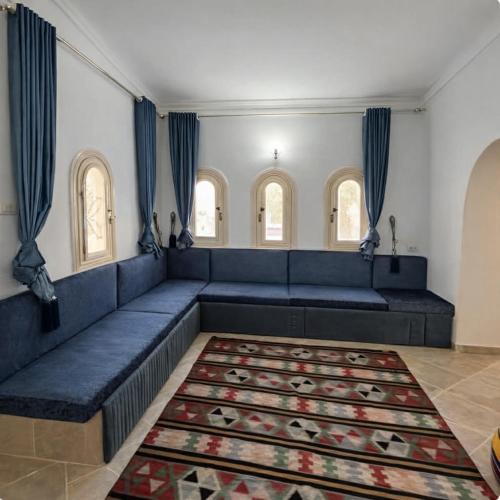 a living room with a blue couch and a rug at Beach Family Villa - Private Pool - Sea view - Up to 14 guests- only 40 Meters to the Beach! in Alexandria