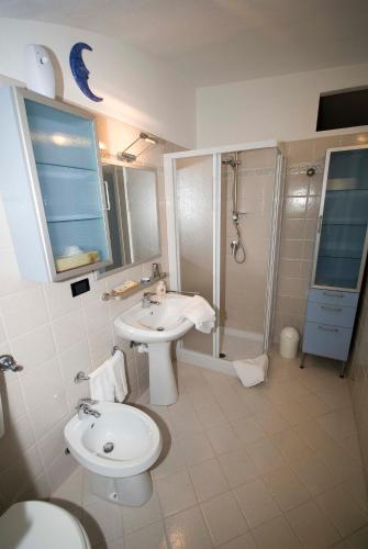 a bathroom with a sink and a toilet and a shower at Archi del '400 Appartamento in Barolo