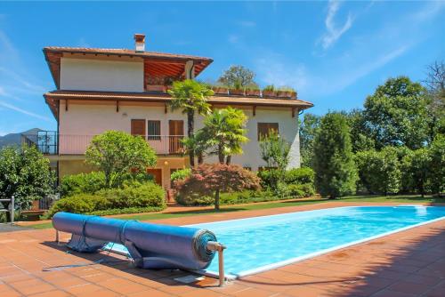 a house with a swimming pool in front of a house at Eden Rock in Cannobio