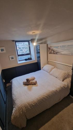 a bed with a stuffed animal on top of it at Penbryn Holidays No 2 in Barmouth
