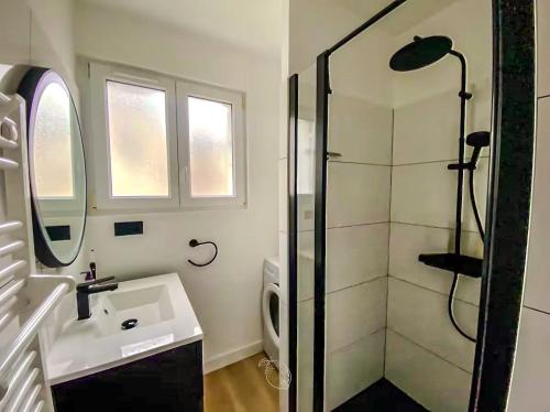 a white bathroom with a shower and a sink at Coconing Plage Pléneuf Val André in Pléneuf-Val-André