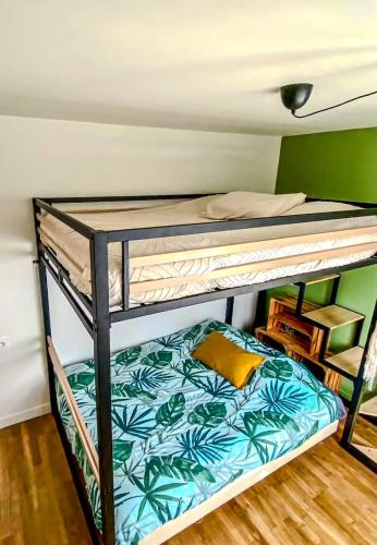a bunk bed in a room with a bed on top at Coconing Plage Pléneuf Val André in Pléneuf-Val-André