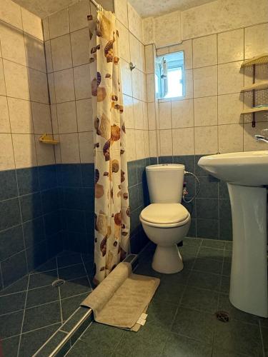 a bathroom with a toilet and a sink at Villa Climate Guest House in Varna City