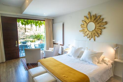 a bedroom with a large bed with a mirror on the wall at La Almunia del Valle in Monachil