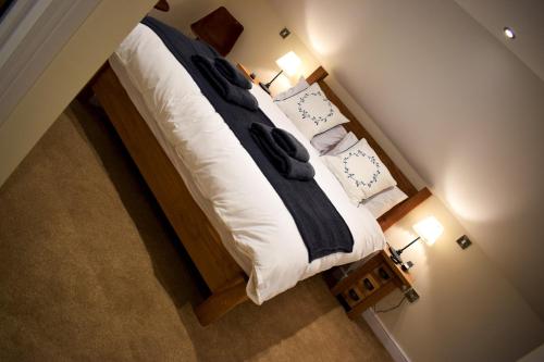a bed in a bedroom with a white bedspread at The Horse & Jockey in Alfreton