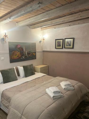 a bedroom with a large bed with towels on it at Daphne Retreat in Kernitsa