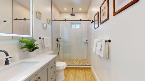 a bathroom with a shower and a toilet and a sink at The Beach House in Ocean City
