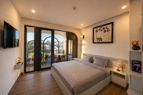a bedroom with a bed and a large window at Happy Life Hotel DaLat in Da Lat