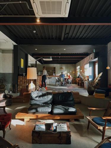 a living room with a couch and a table at Lemonsea Onomichi in Onomichi