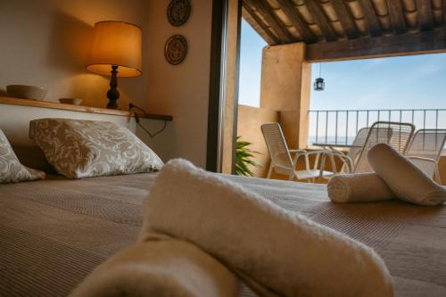 a bedroom with a bed with a view of the ocean at Loft con chimenea y terraza con vistas - Cal Caterino in Montsonis