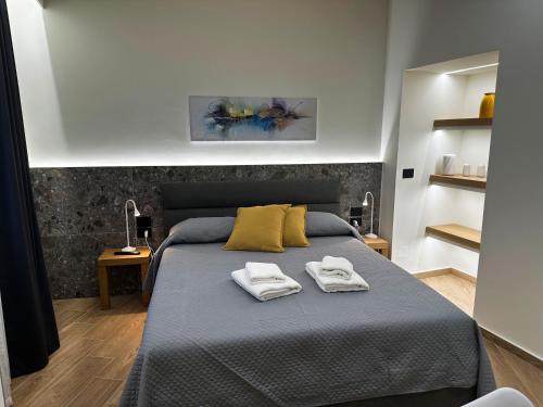 a bedroom with a bed with two towels on it at Palazzo delle Belle in Catania