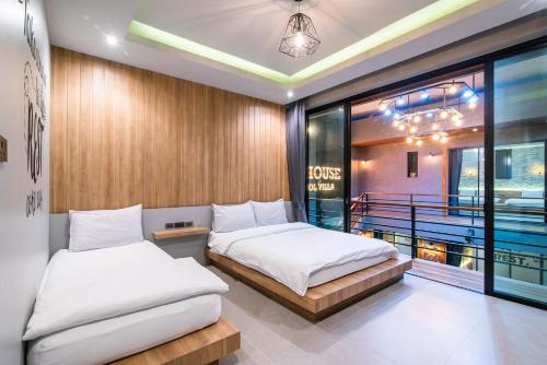 two beds in a room with a balcony at Playa Huahin by Ying in Hua Hin