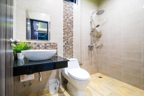 a bathroom with a sink and a toilet and a shower at Playa Huahin by Ying in Hua Hin