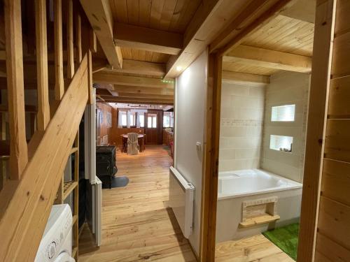 a large bathroom with a tub in a house at La Marguerite in Aigueblanche
