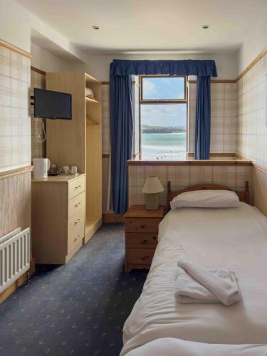 a bedroom with a large bed and a window at Harbour Heights B&B in Portrush