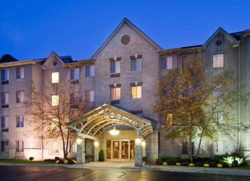 a large brick building with an entry way at Staybridge Suites Chicago-Oakbrook Terrace by IHG in Oakbrook Terrace