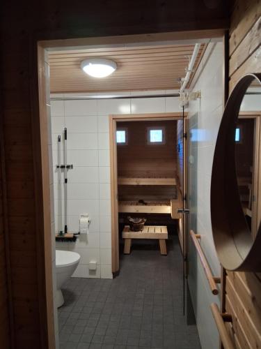 a bathroom with a tub and a toilet and a sink at Hostelli Havumaja in Puumala