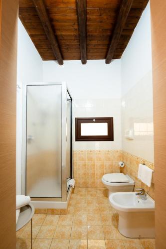 a bathroom with two toilets and a shower at Porta delle Botteghelle in Trapani