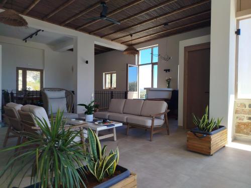 a living room with a couch and a table at Alexena Apartments in Agia Galini