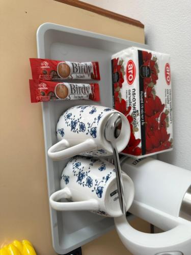 a refrigerator with a bunch of cups and headphones in it at Baan Smile in Patong Beach