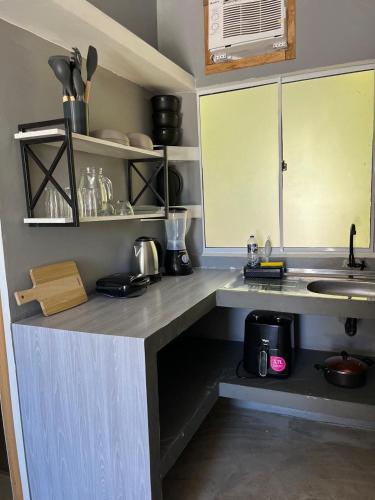 a kitchen with a sink and a counter top at Condomíno dos Chalés in Porto Seguro