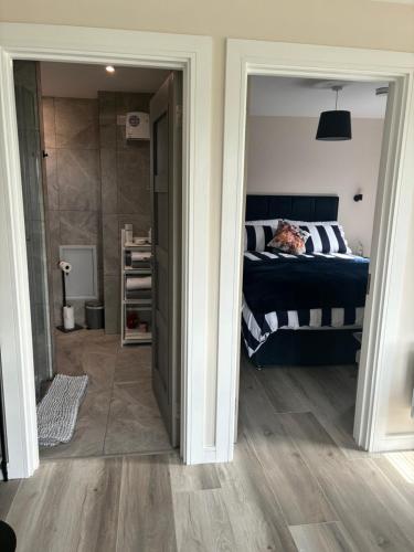 a bedroom with a bed and a walk in closet at Heron's Rest Studio in Macroom