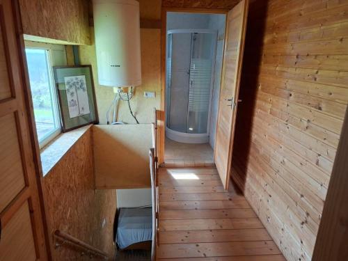 a bathroom with a shower and a staircase in a room at Mara Ház in Lengyel